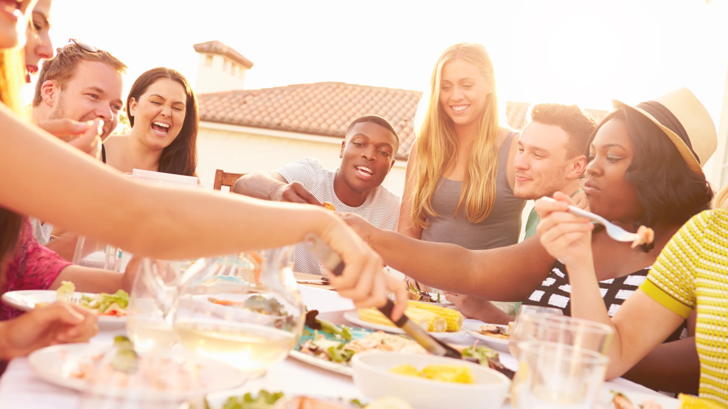 Group of friends enjoying a meal together outdoors.